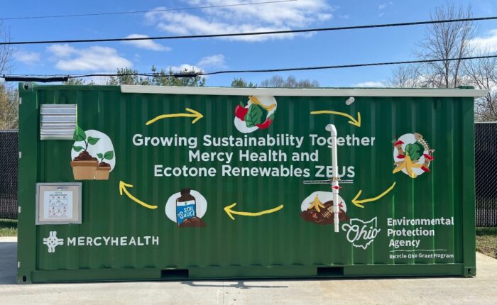 dumpster that reads Growing Sustainability Together Mercy Health and Ecotone Renewables