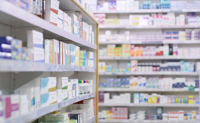 pharmacy Rows of shelves stocked with medicine boxes and bottles in a pharmacy, with the foreground shelf in sharp focus and the background shelves blurred